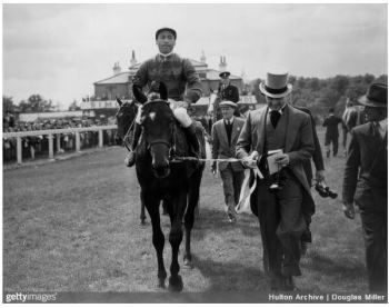 28th May 1952: Prince Aly Khan, son of His Highness the Aga Khan III, leads in his horse, Tulyar after it had won the Derby at Epsom. (Photo by Douglas MillerFox Photos/Getty Images)
